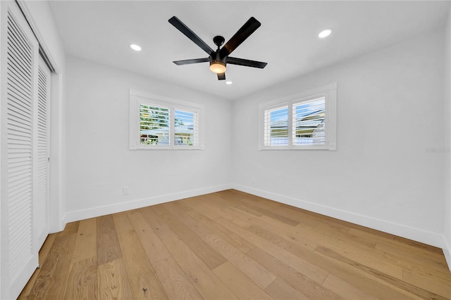 8001 13th Ave S, Saint Petersburg, FL 33707 - unfurnished bedroom featuring a closet, multiple windows, light wood-type flooring, recessed lighting, and ceiling fan