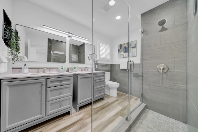8001 13th Ave S, Saint Petersburg, FL 33707 - full bathroom with vanity, a stall shower, tile walls, wainscoting, and recessed lighting