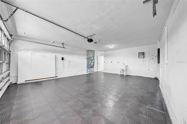 8001 13th Ave S, Saint Petersburg, FL 33707 - garage with a garage door opener and electric panel