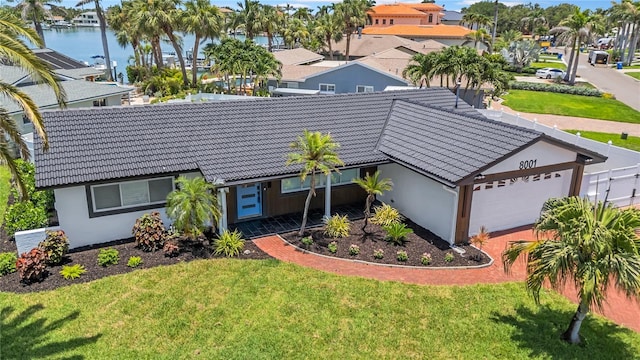 8001 13th Ave S, Saint Petersburg, FL 33707 - view of front facade featuring a tile roof, a residential view, and a garage