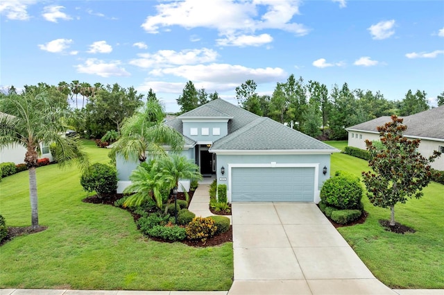 4654 Claremont Park Dr, Bradenton, FL 34211 - view of front of house with an attached garage, a shingled roof, a front yard, concrete driveway, and stucco siding