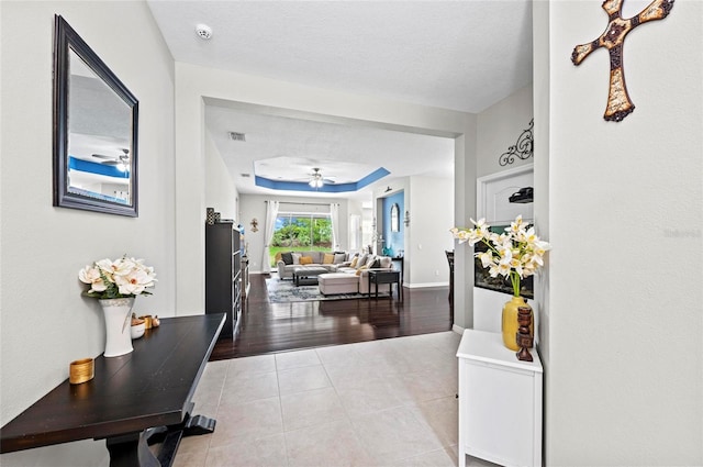 4654 Claremont Park Dr, Bradenton, FL 34211 - hallway with a tray ceiling and tile patterned floors