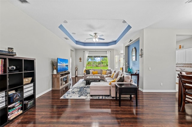 4654 Claremont Park Dr, Bradenton, FL 34211 - living area with a tray ceiling, dark wood-style flooring, and ceiling fan