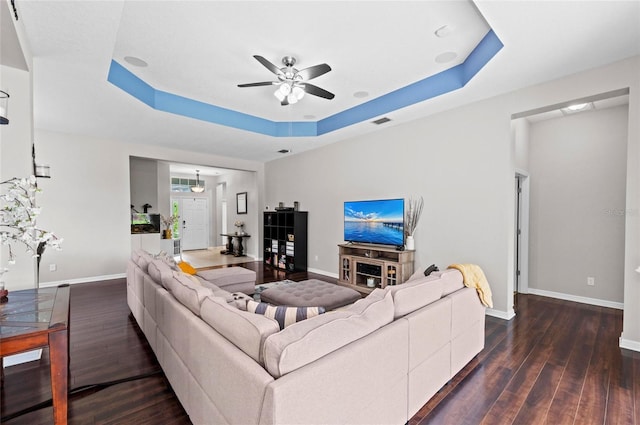 4654 Claremont Park Dr, Bradenton, FL 34211 - living room with a raised ceiling, a ceiling fan, and dark wood-style floors