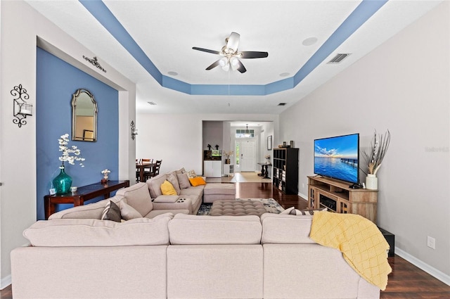4654 Claremont Park Dr, Bradenton, FL 34211 - living room featuring dark wood finished floors, ceiling fan, and a raised ceiling
