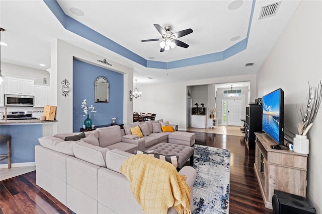 4654 Claremont Park Dr, Bradenton, FL 34211 - living room with a ceiling fan, dark wood-style floors, and a raised ceiling