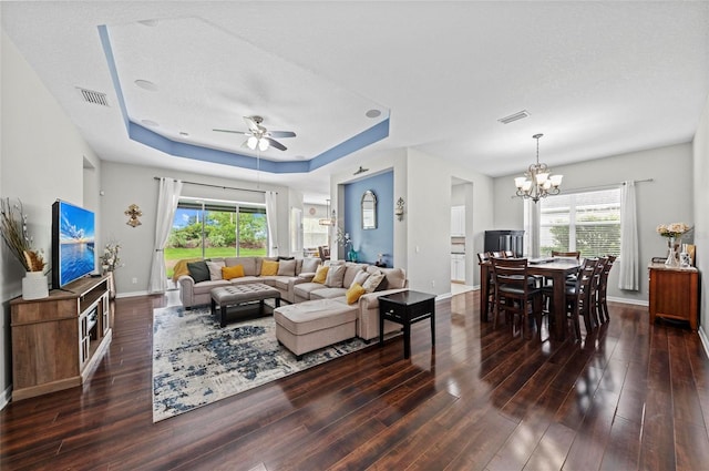 4654 Claremont Park Dr, Bradenton, FL 34211 - living area featuring wood finished floors, a raised ceiling, a ceiling fan, and a chandelier