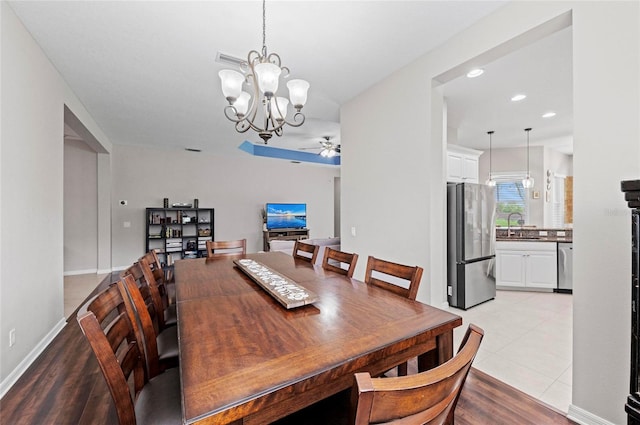 4654 Claremont Park Dr, Bradenton, FL 34211 - dining area with a chandelier, ceiling fan, recessed lighting, and light wood-style flooring