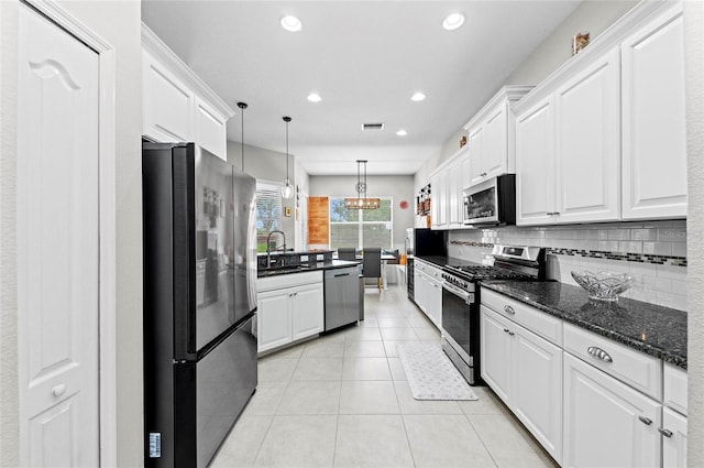 4654 Claremont Park Dr, Bradenton, FL 34211 - kitchen featuring appliances with stainless steel finishes, white cabinets, decorative backsplash, light tile patterned floors, and recessed lighting