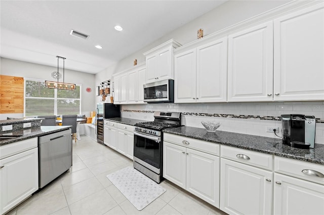 4654 Claremont Park Dr, Bradenton, FL 34211 - kitchen featuring stainless steel appliances, backsplash, white cabinets, pendant lighting, and a chandelier
