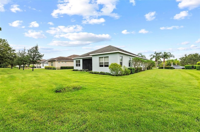 4654 Claremont Park Dr, Bradenton, FL 34211 - view of side of property with a yard and stucco siding