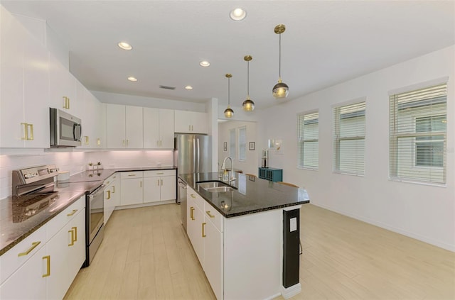 3602 Secret Stroll Dr, Sarasota, FL 34240 - kitchen featuring appliances with stainless steel finishes, tasteful backsplash, light wood-type flooring, hanging light fixtures, and recessed lighting