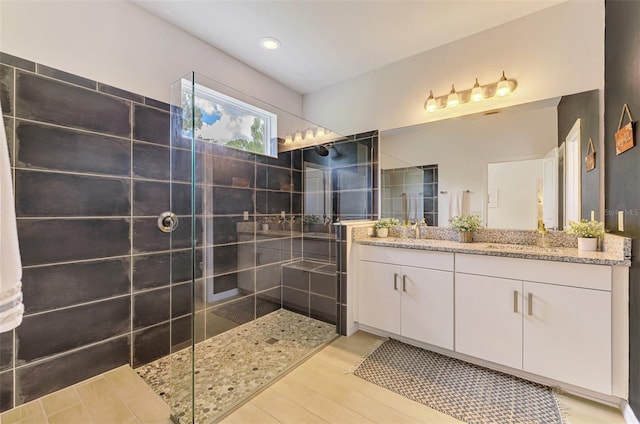 3602 Secret Stroll Dr, Sarasota, FL 34240 - full bathroom with double vanity, a walk in shower, and wood finished floors