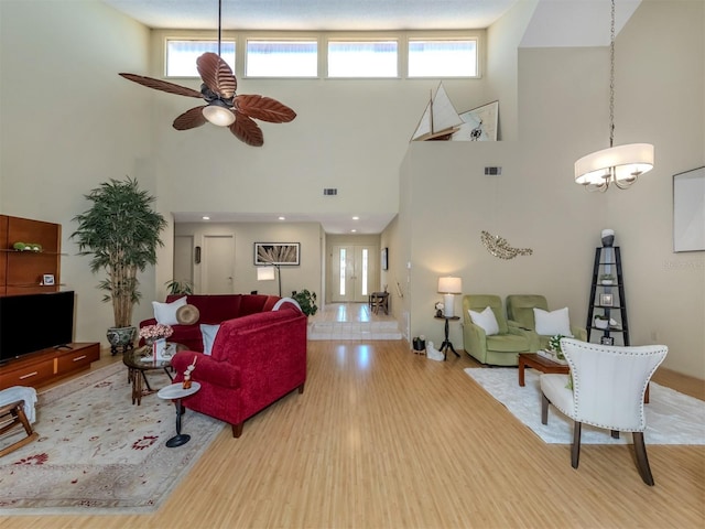 154 Inlets Blvd, Nokomis, FL 34275 - living room with a high ceiling, healthy amount of natural light, wood finished floors, and ceiling fan