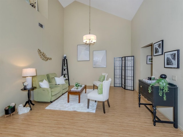 154 Inlets Blvd, Nokomis, FL 34275 - living area featuring high vaulted ceiling, light wood-style floors, and a chandelier