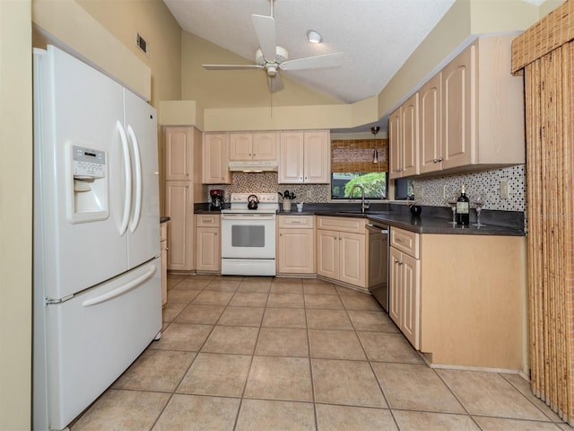 154 Inlets Blvd, Nokomis, FL 34275 - kitchen with white appliances, under cabinet range hood, vaulted ceiling, backsplash, and dark countertops