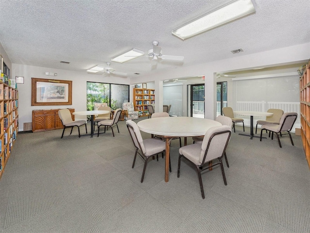 154 Inlets Blvd, Nokomis, FL 34275 - dining area featuring ceiling fan, light colored carpet, and a textured ceiling