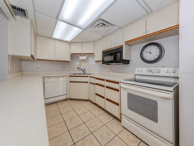 154 Inlets Blvd, Nokomis, FL 34275 - kitchen featuring white appliances, light countertops, light tile patterned floors, and white cabinets