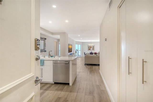 1000 Longboat Club Rd Unit 1105, Longboat Key, FL 34228 - kitchen featuring stainless steel dishwasher, light wood finished floors, a peninsula, light countertops, and recessed lighting