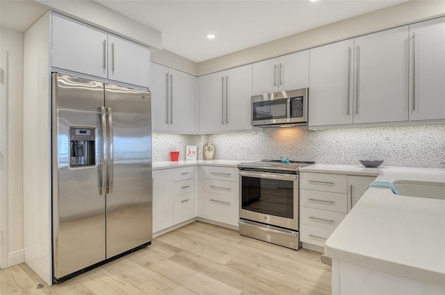 1000 Longboat Club Rd Unit 1105, Longboat Key, FL 34228 - kitchen featuring stainless steel appliances, light wood-type flooring, light countertops, recessed lighting, and decorative backsplash