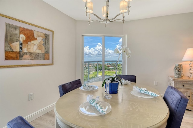 1000 Longboat Club Rd Unit 1105, Longboat Key, FL 34228 - dining area featuring a chandelier and light wood-style floors