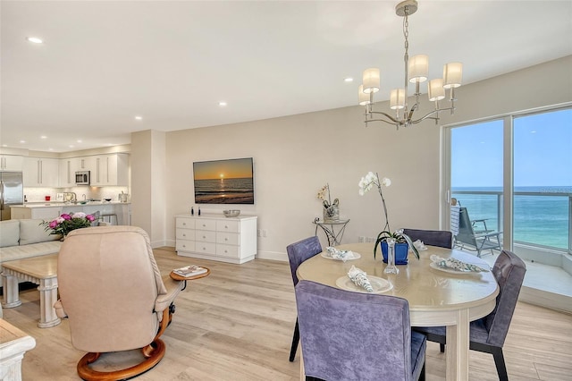 1000 Longboat Club Rd Unit 1105, Longboat Key, FL 34228 - dining room with a chandelier, recessed lighting, light wood finished floors, and a water view