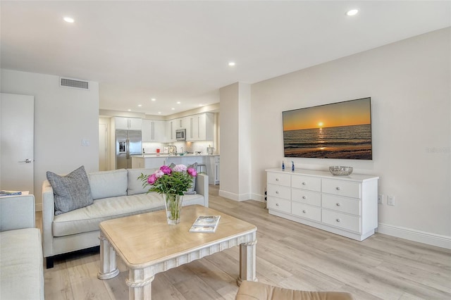 1000 Longboat Club Rd Unit 1105, Longboat Key, FL 34228 - living room with light wood-style flooring and recessed lighting