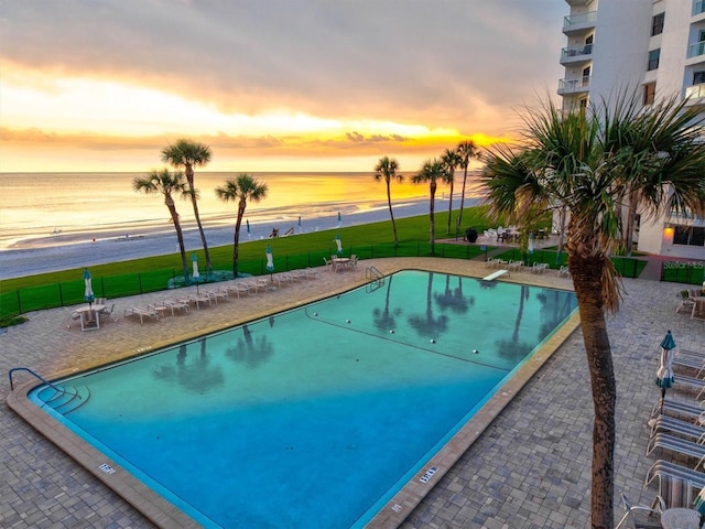 1000 Longboat Club Rd Unit 1105, Longboat Key, FL 34228 - pool at dusk with a water view, a community pool, and a patio