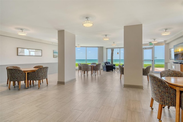 1000 Longboat Club Rd Unit 1105, Longboat Key, FL 34228 - dining room with a wall of windows and light wood-type flooring