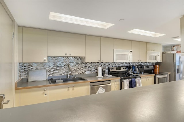 1000 Longboat Club Rd Unit 1105, Longboat Key, FL 34228 - kitchen with stainless steel appliances, cream cabinets, backsplash, and a skylight