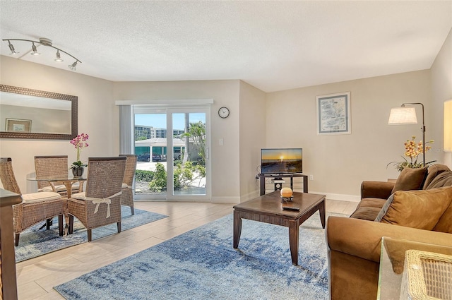 1000 Longboat Club Rd Unit 1105, Longboat Key, FL 34228 - living room with light tile patterned floors, track lighting, and a textured ceiling