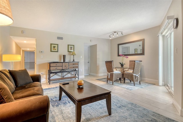 1000 Longboat Club Rd Unit 1105, Longboat Key, FL 34228 - living room with light wood-type flooring and a textured ceiling