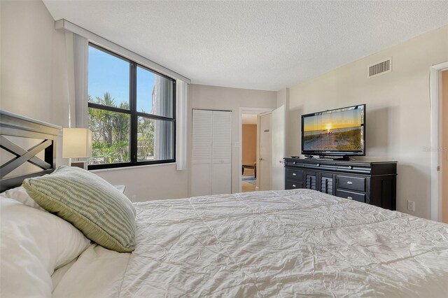 1000 Longboat Club Rd Unit 1105, Longboat Key, FL 34228 - bedroom with a textured ceiling and a closet