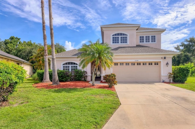 12342 Lavender Loop, Bradenton, FL 34212 - view of front of property featuring stucco siding, driveway, a front lawn, and roof with shingles