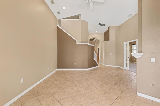 12342 Lavender Loop, Bradenton, FL 34212 - unfurnished living room featuring high vaulted ceiling, arched walkways, a ceiling fan, light tile patterned flooring, and stairs