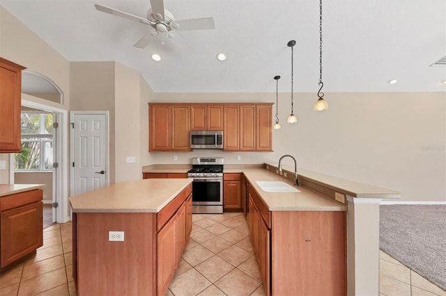 12342 Lavender Loop, Bradenton, FL 34212 - kitchen featuring stainless steel appliances, light countertops, light tile patterned flooring, vaulted ceiling, and a peninsula