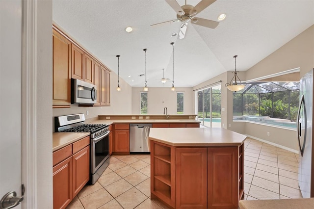 12342 Lavender Loop, Bradenton, FL 34212 - kitchen featuring appliances with stainless steel finishes, a ceiling fan, lofted ceiling, a peninsula, and light tile patterned floors