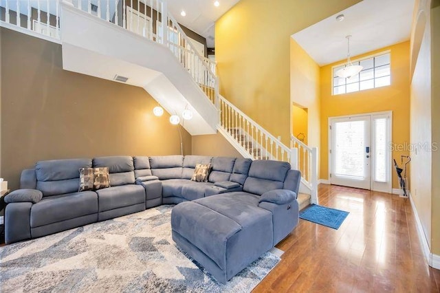4127 Middle River Ter, Ellenton, FL 34222 - living room featuring a high ceiling, stairs, and wood finished floors
