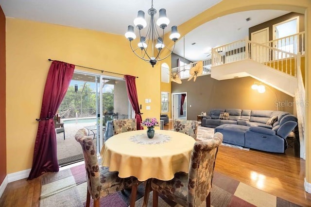 4127 Middle River Ter, Ellenton, FL 34222 - dining room with wood finished floors, a chandelier, a towering ceiling, arched walkways, and stairway
