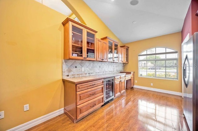 4127 Middle River Ter, Ellenton, FL 34222 - indoor dry bar with beverage cooler, freestanding refrigerator, decorative backsplash, light wood-type flooring, and vaulted ceiling
