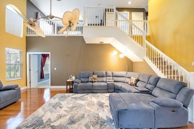 4127 Middle River Ter, Ellenton, FL 34222 - living room featuring wood finished floors, a ceiling fan, a towering ceiling, and stairway