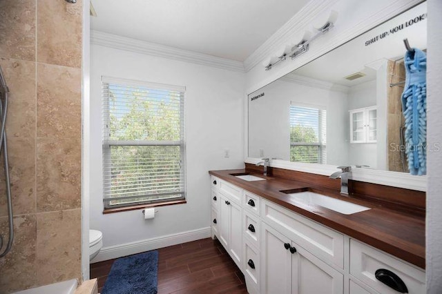 4127 Middle River Ter, Ellenton, FL 34222 - full bathroom with double vanity, a tile shower, wood finished floors, and ornamental molding