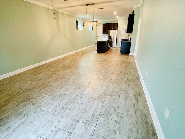 5635 Los Robles Ct, Palmetto, FL 34221 - unfurnished living room featuring ornamental molding and light wood-type flooring