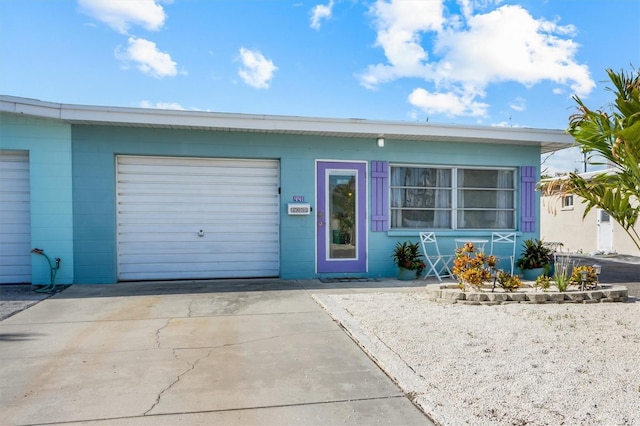 441 62nd St, Holmes Beach, FL 34217 - view of front facade featuring an attached garage, driveway, and concrete block siding