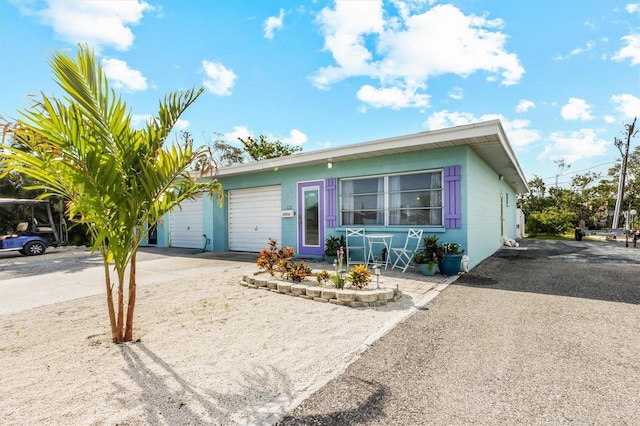 441 62nd St, Holmes Beach, FL 34217 - ranch-style home featuring concrete driveway and an attached garage