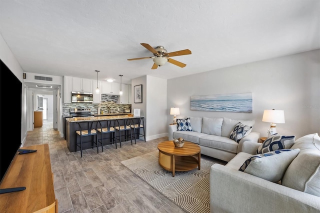 441 62nd St, Holmes Beach, FL 34217 - living area featuring a ceiling fan and light wood-style flooring