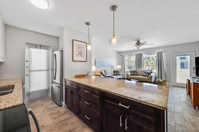 441 62nd St, Holmes Beach, FL 34217 - kitchen featuring freestanding refrigerator, range with electric stovetop, a peninsula, open floor plan, and a ceiling fan