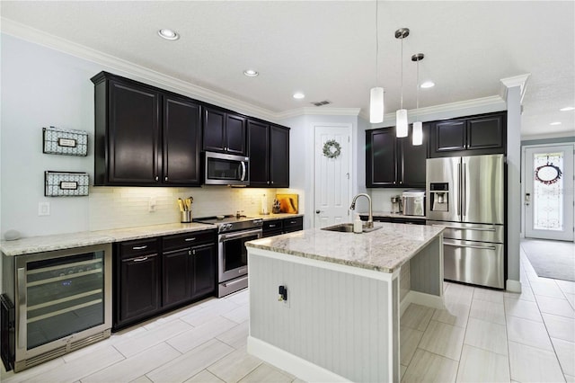 731 116th Ct NE, Bradenton, FL 34212 - kitchen with appliances with stainless steel finishes, beverage cooler, dark cabinets, ornamental molding, and recessed lighting