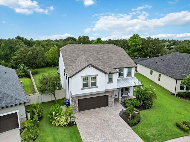 731 116th Ct NE, Bradenton, FL 34212 - view of front of home with stucco siding, a standing seam roof, stone siding, roof with shingles, and decorative driveway