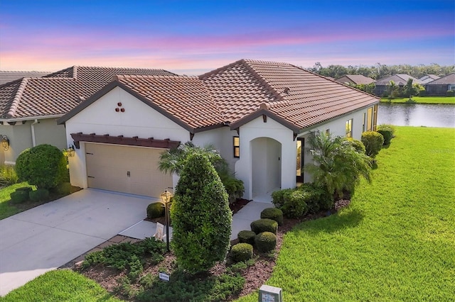 12641 Coastal Breeze Way, Bradenton, FL 34211 - mediterranean / spanish house featuring stucco siding, a front yard, an attached garage, and a tiled roof